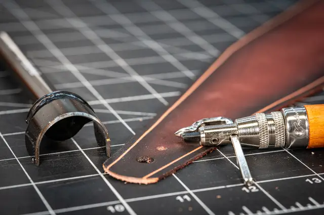 Burnishing a strap edge with a slicker