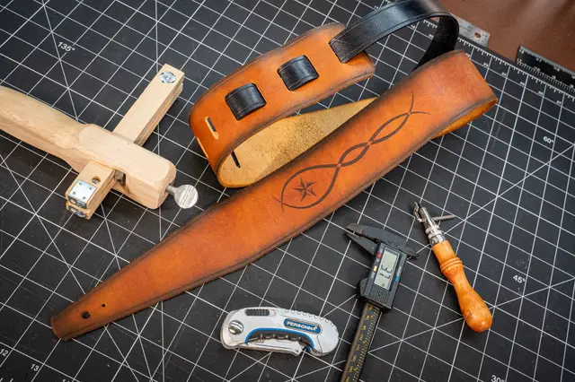 A finished strap with the star pattern, surrounded by tools