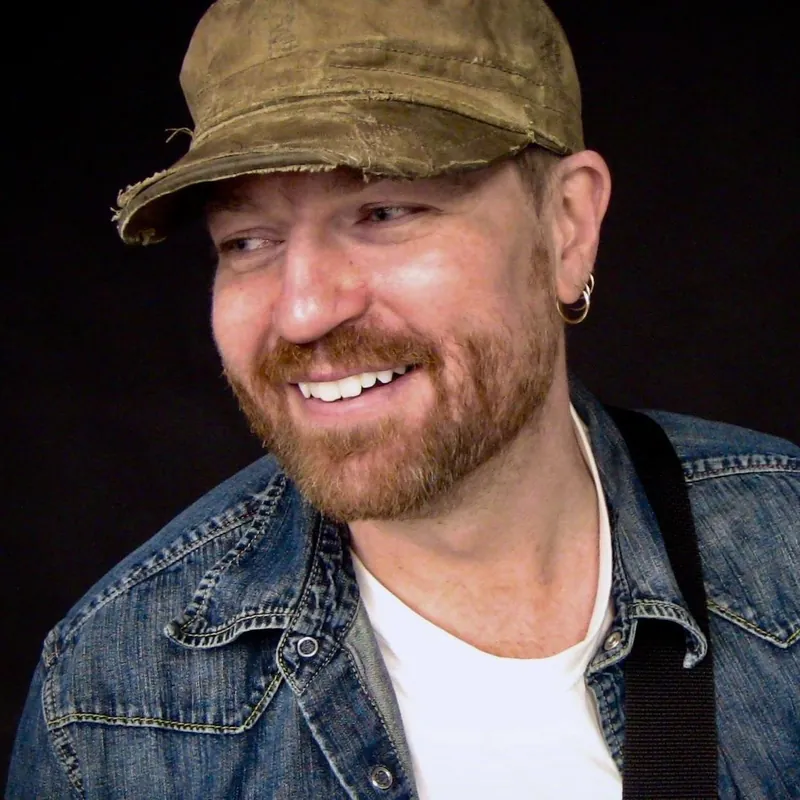 Michael Lander: Smiling headshot in a denim jacket